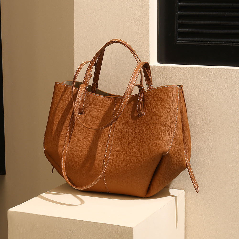 Caramel leather tote on a cream plinth